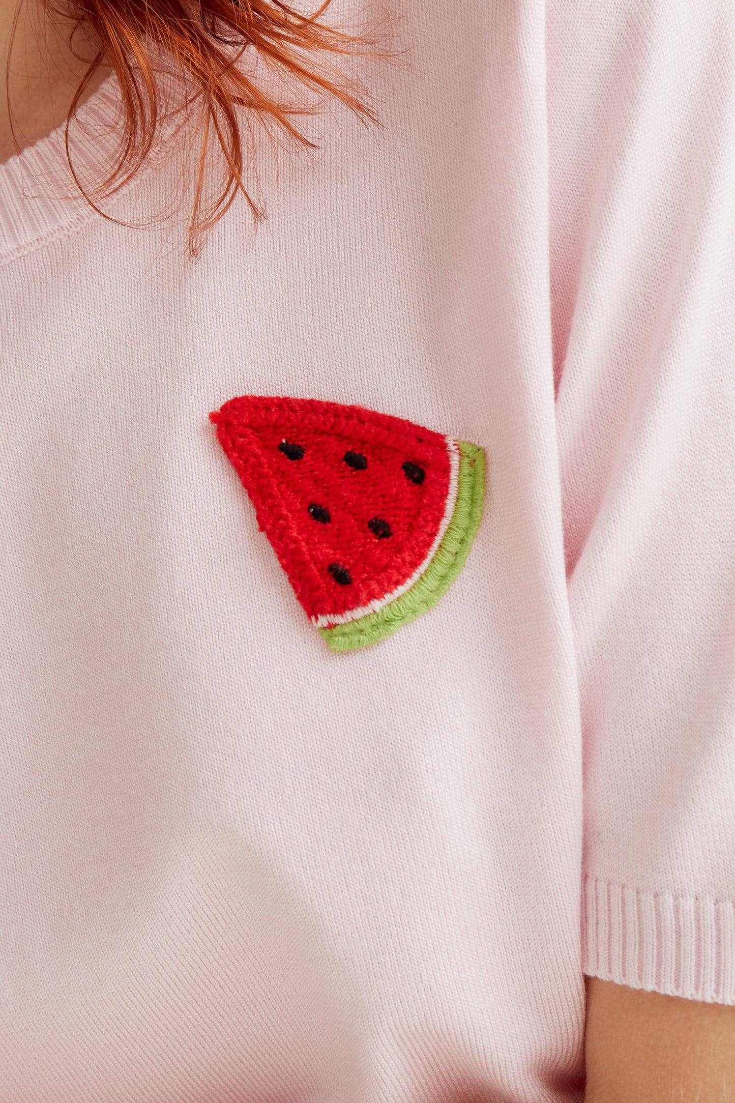 Pink knit top with watermelon embroidery