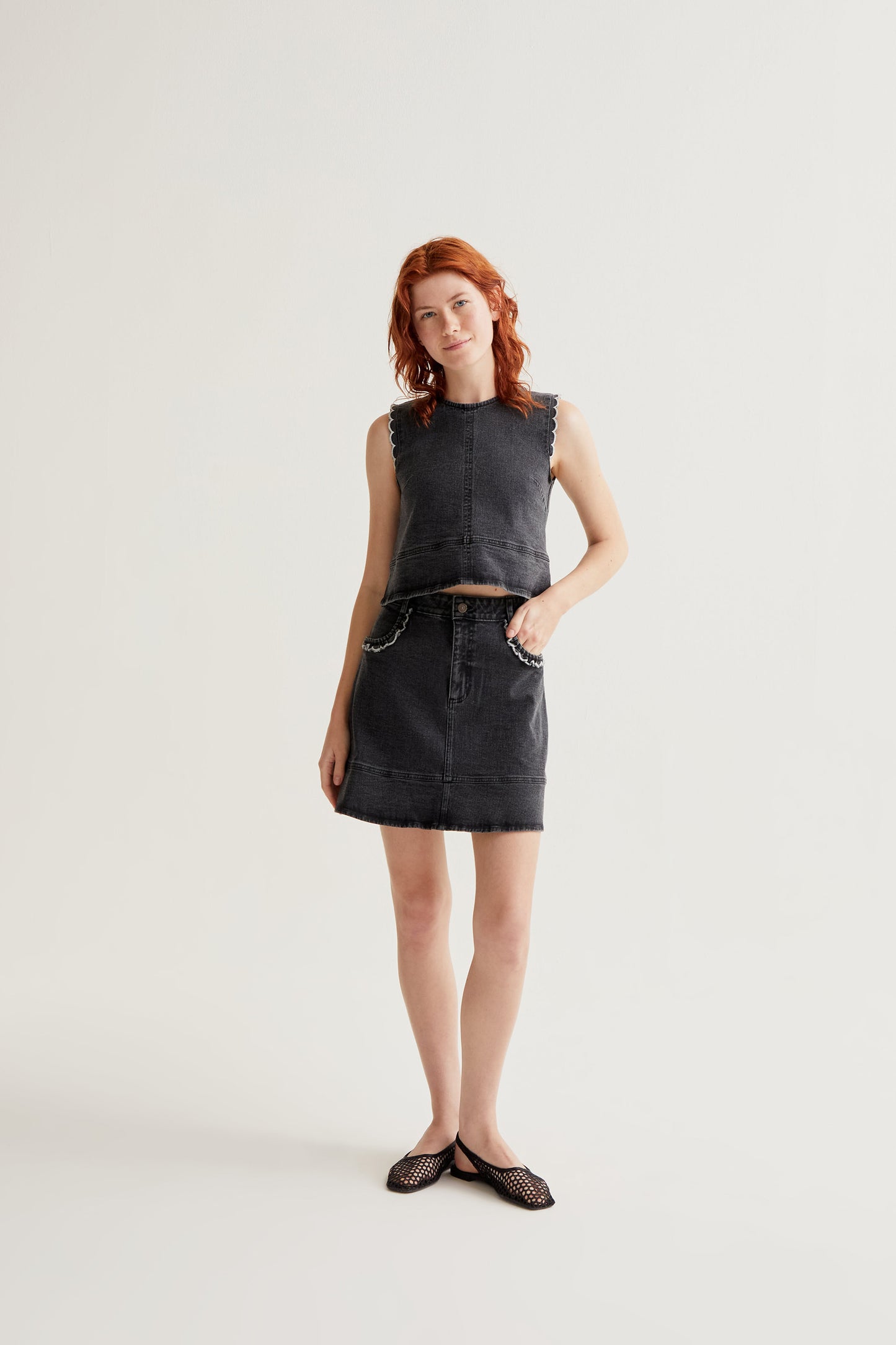 Black denim skirt with ruffle detail