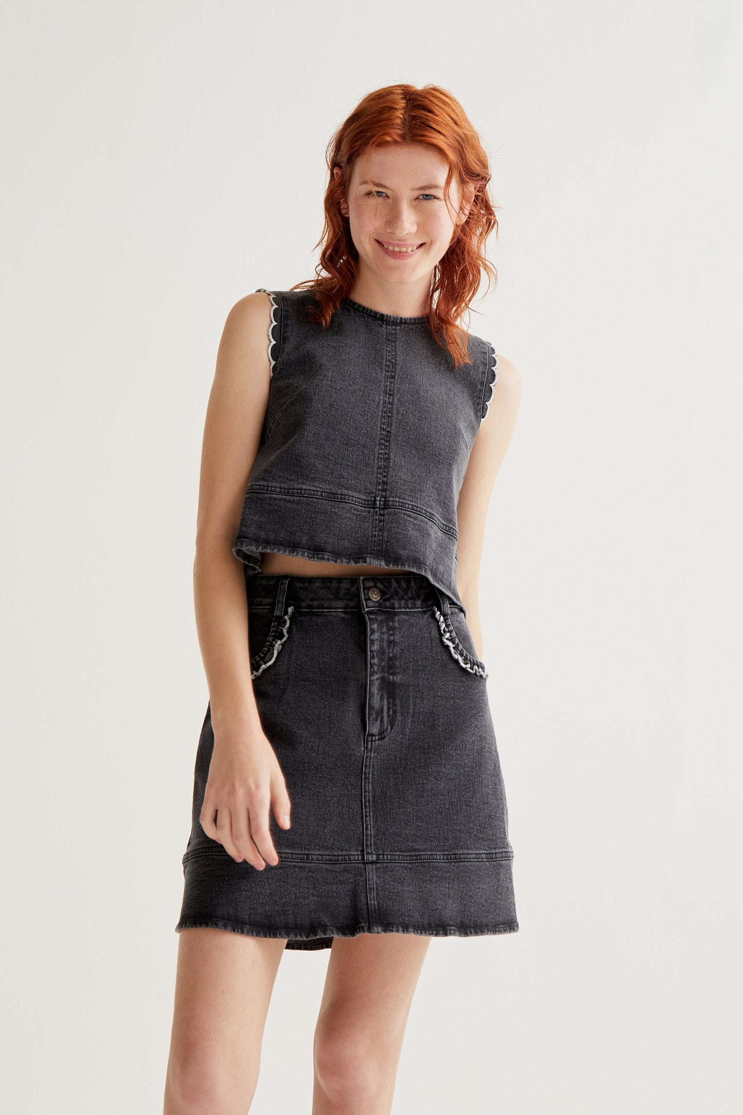 Black denim skirt with ruffle detail