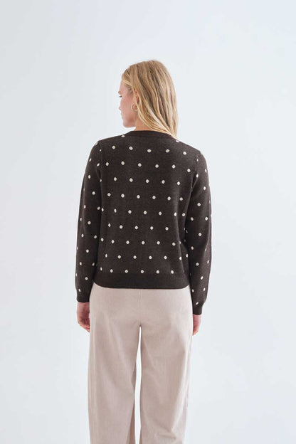 Green cardigan with small white polka dots