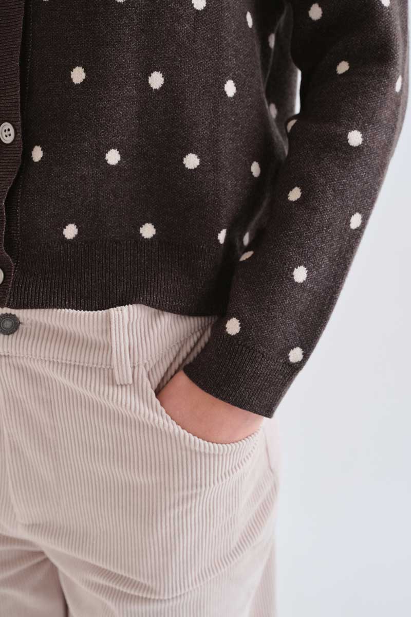 Green cardigan with small white polka dots