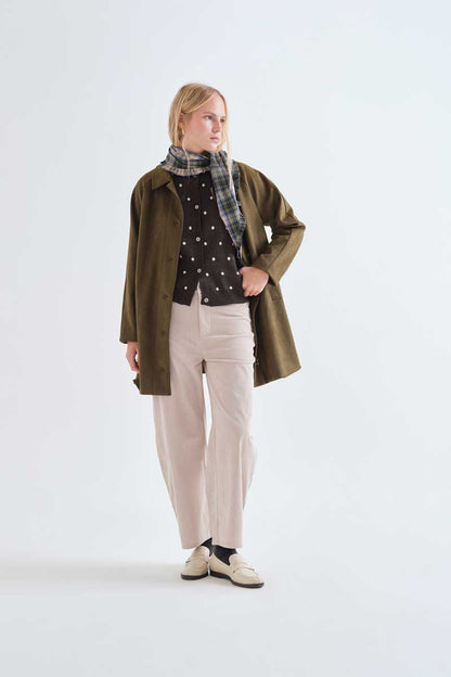 Green cardigan with small white polka dots