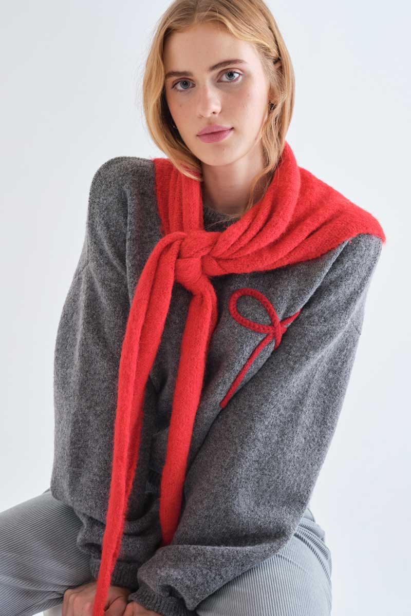 Grey knit jumper with red bow detail