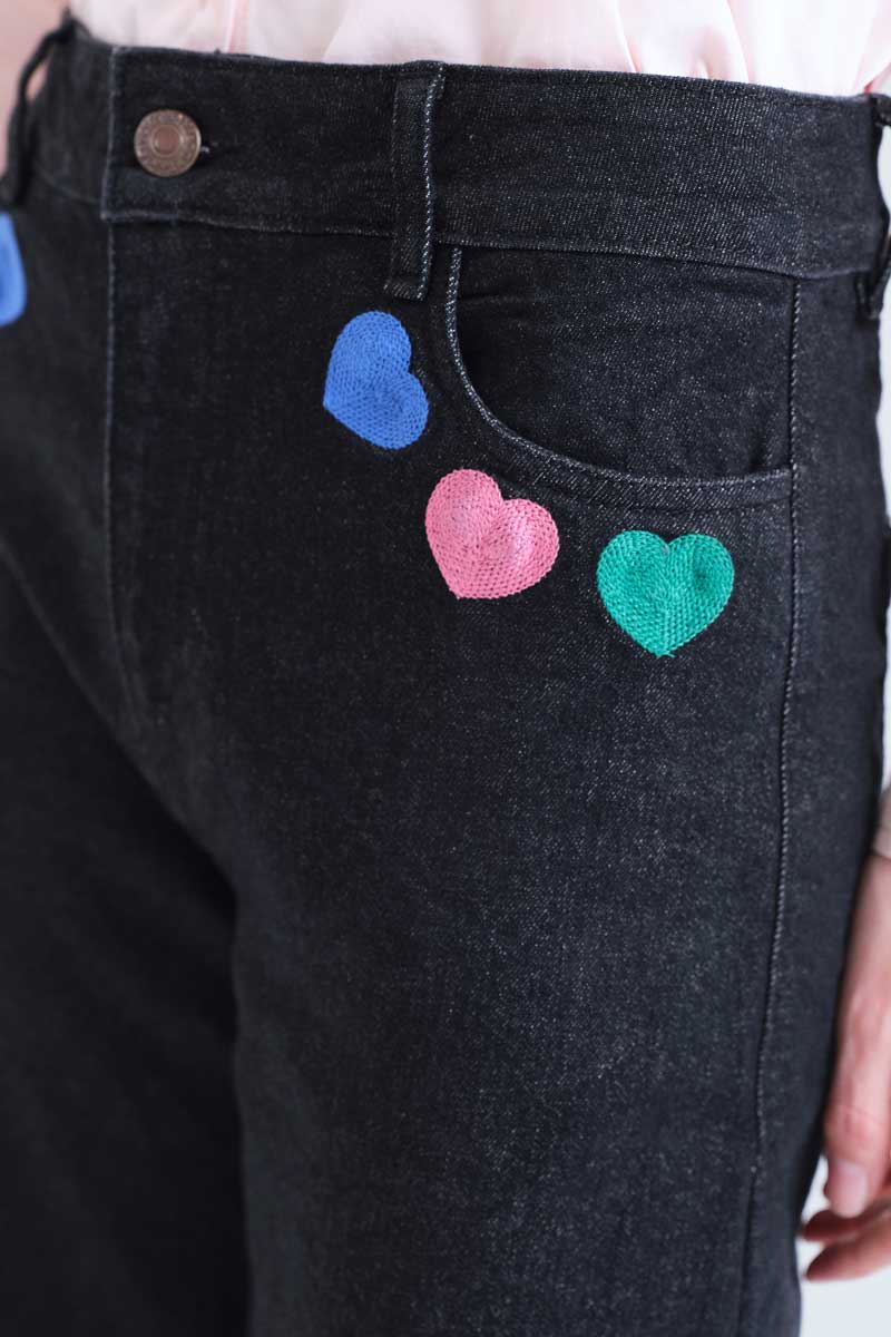 Black denim trousers with Candy print