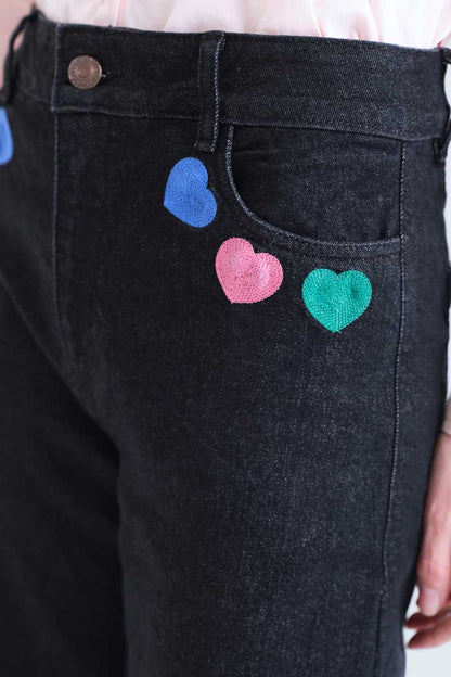 Black denim trousers with Candy print