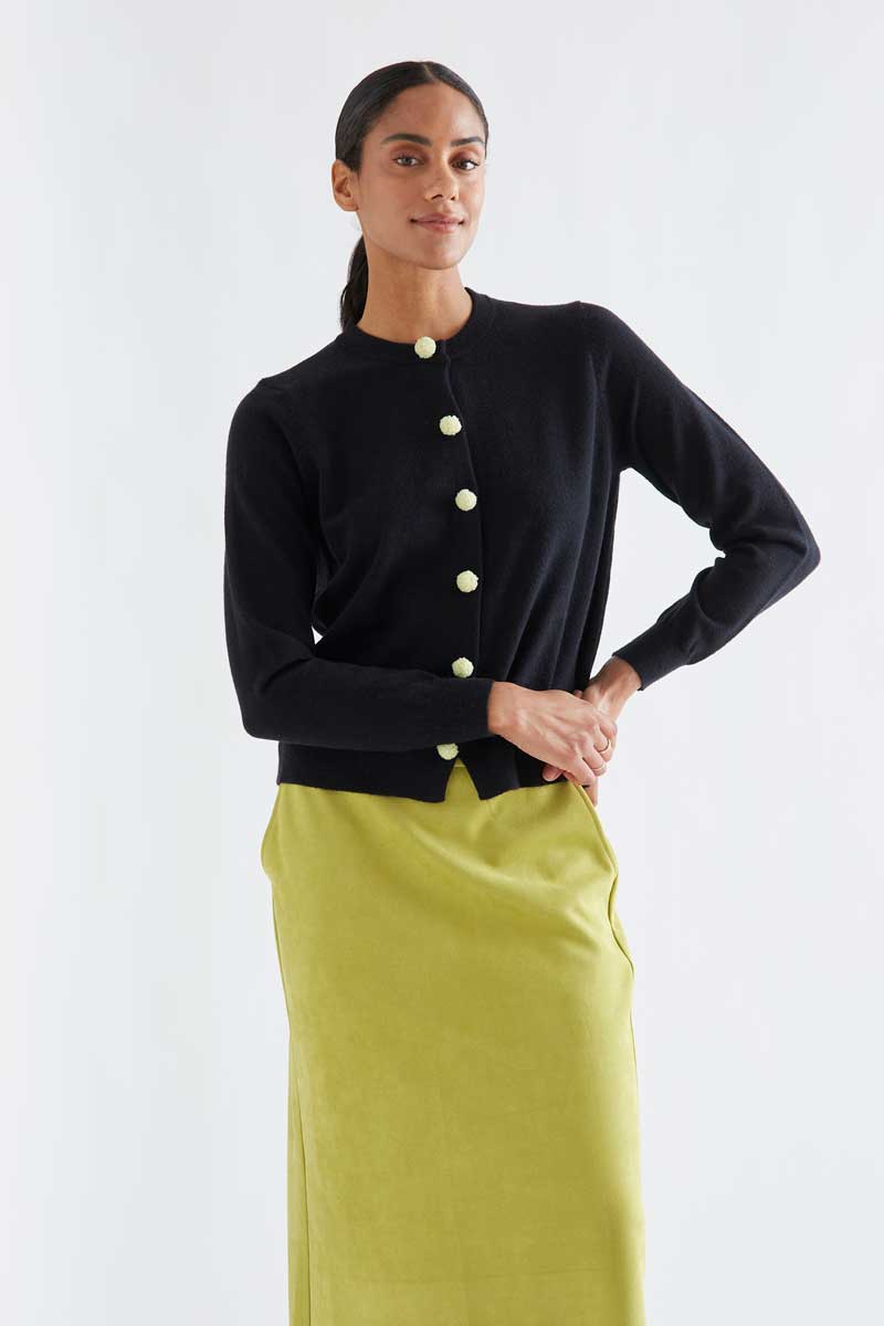 Black cardigan with white pompoms