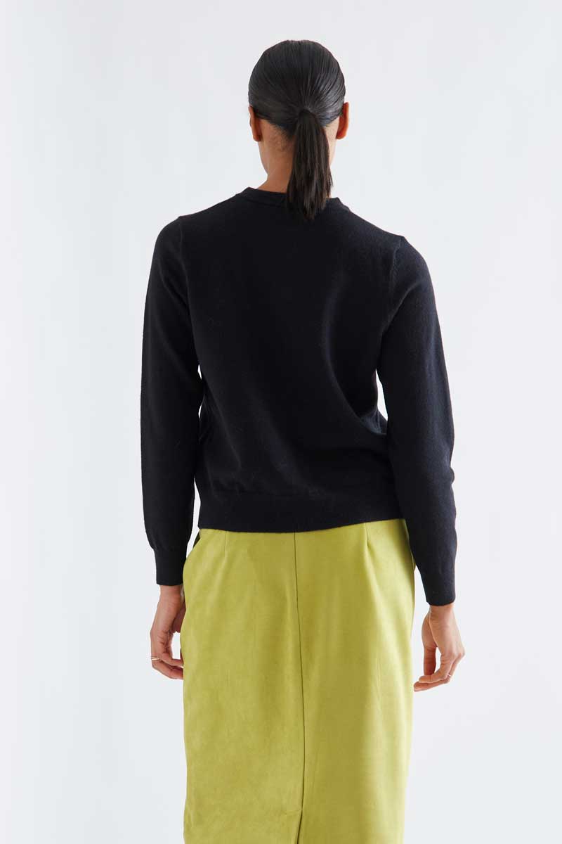 Black cardigan with white pompoms