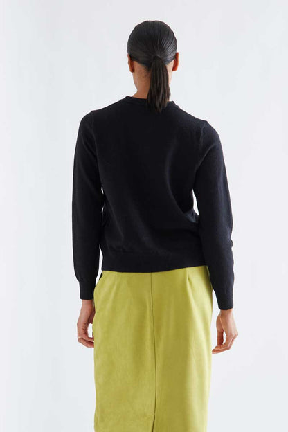 Black cardigan with white pompoms