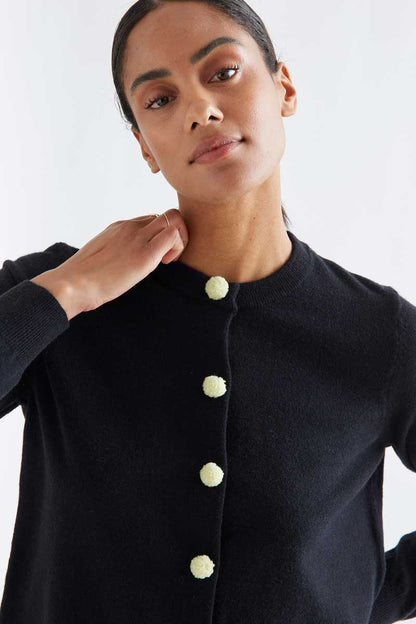 Black cardigan with white pompoms