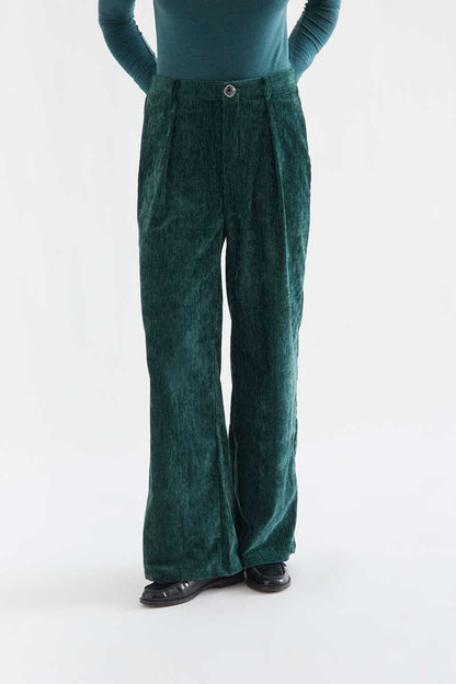 Dark green velvet trousers with a jewel button