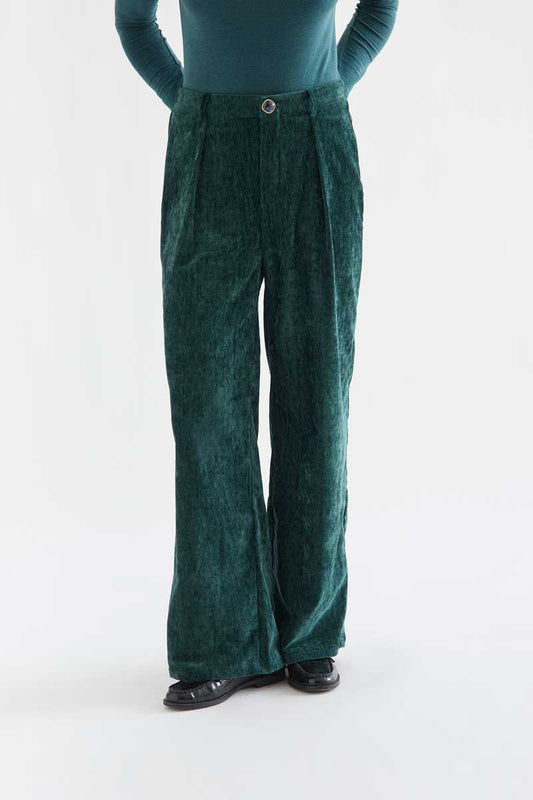 Dark green velvet trousers with a jewel button