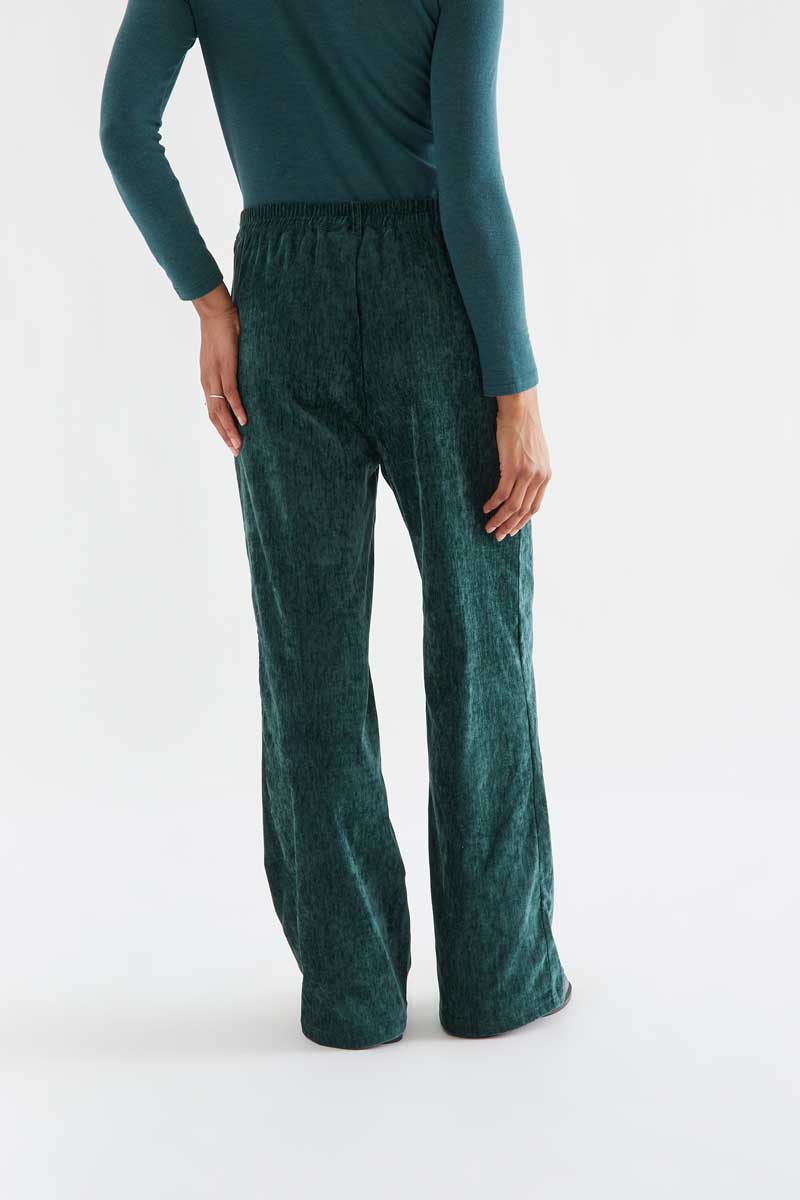 Dark green velvet trousers with a jewel button