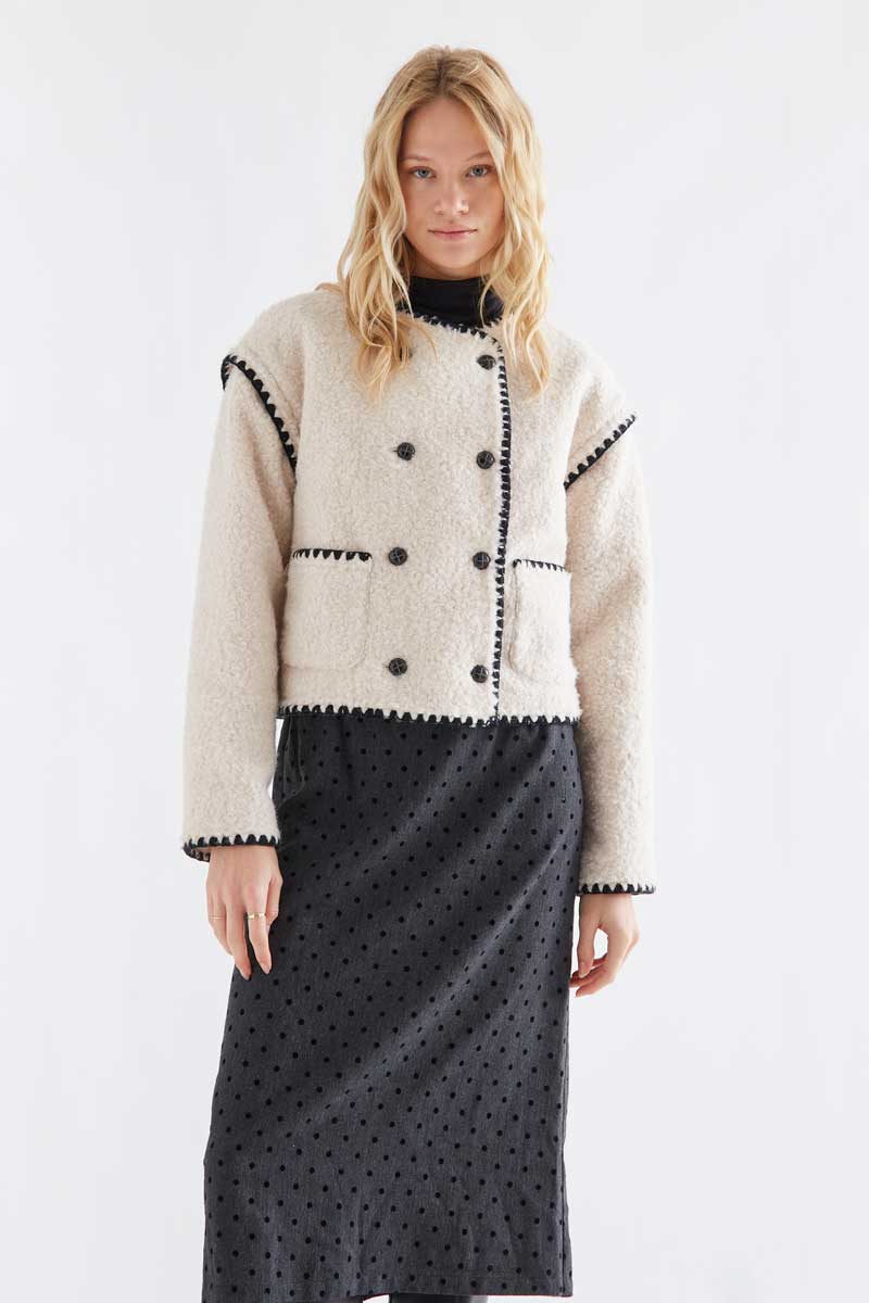 Off-white short faux shearling coat with black accents