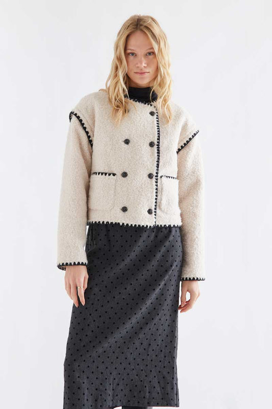Off-white short faux shearling coat with black accents