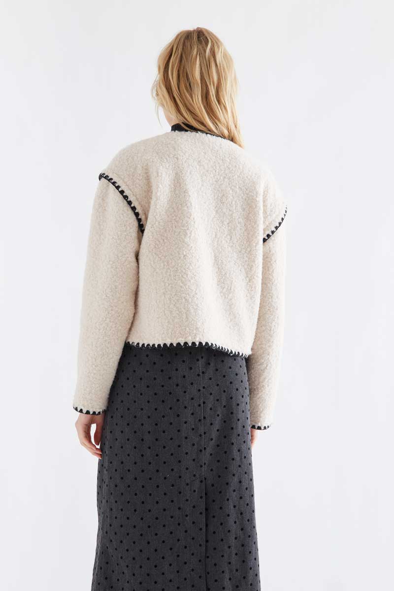 Off-white short faux shearling coat with black accents