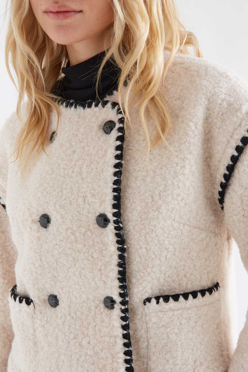 Off-white short faux shearling coat with black accents